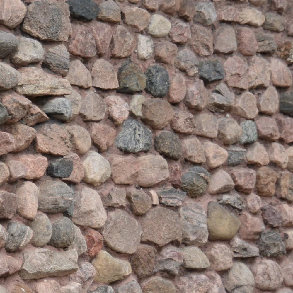 A stone surface, similar to cobblestone, with pink, grey stones